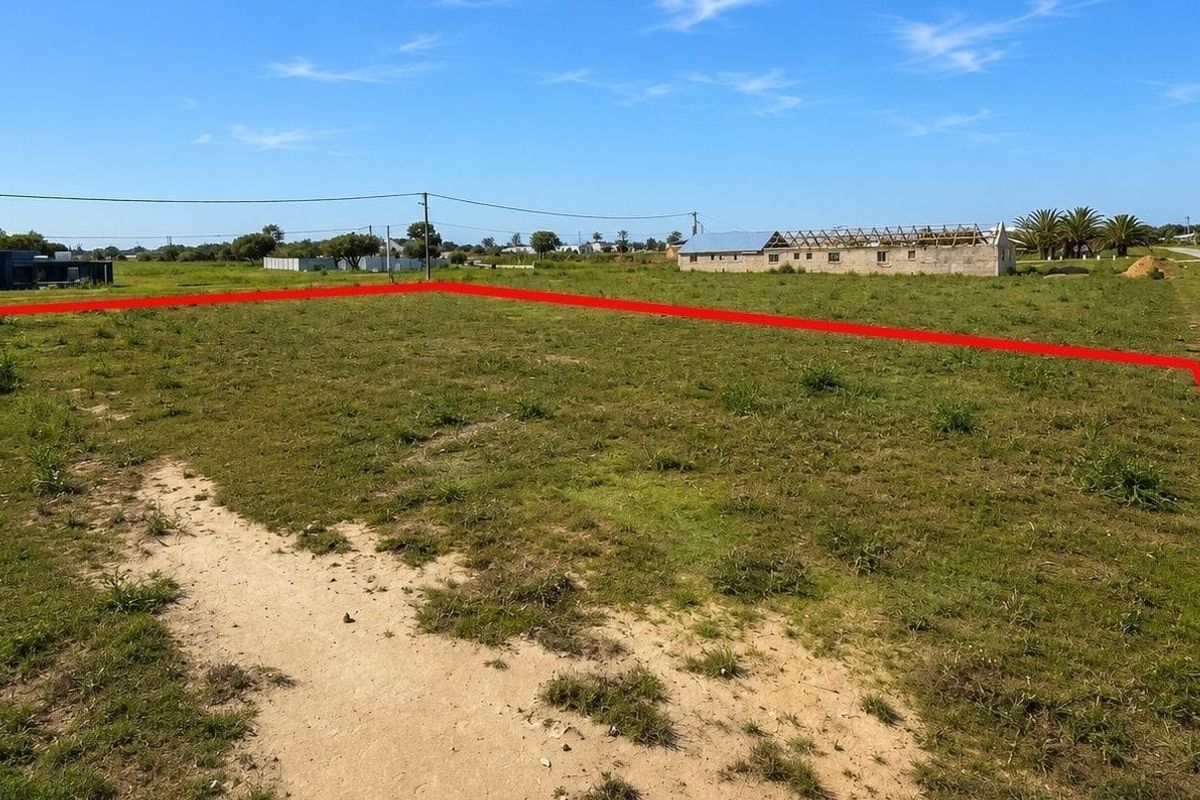 A vacant residential plot of land with clear boundary markings, situated in a developing neighborhood.