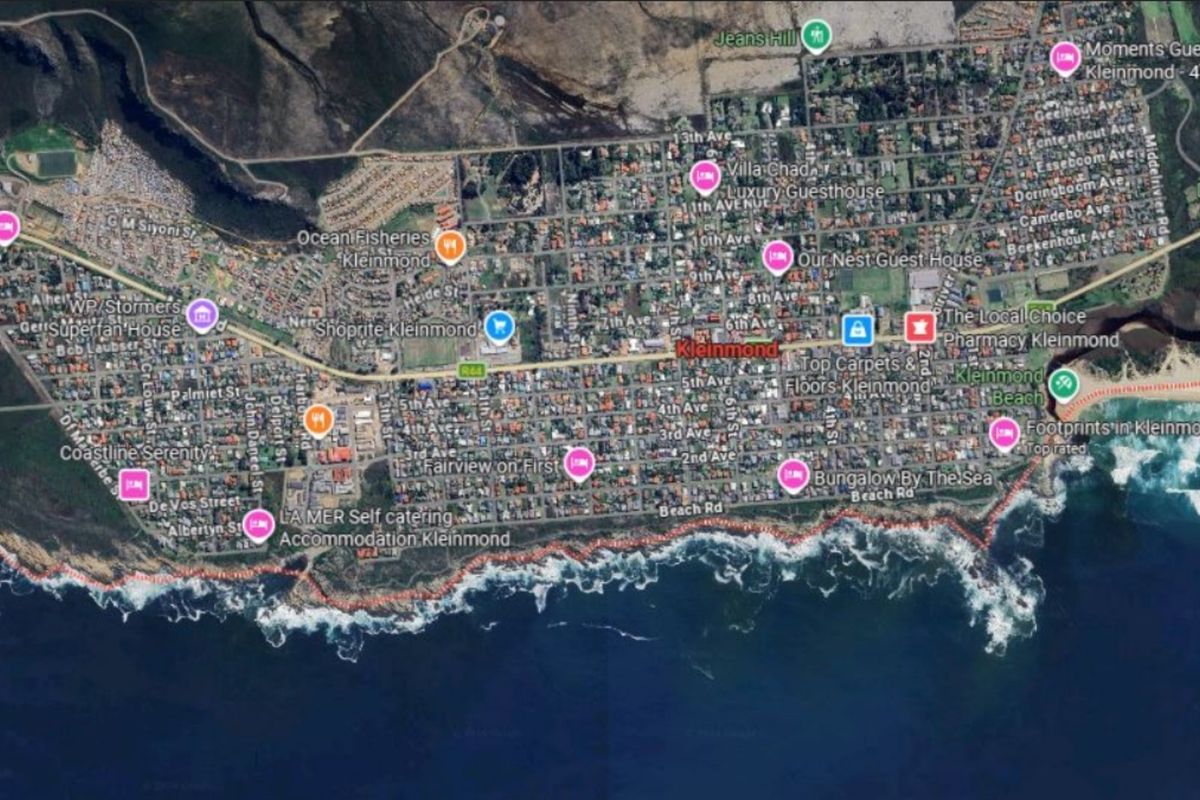 An aerial satellite view of the coastal town of Kleinmond, showing the layout of streets, residential areas, and proximity to the ocean.