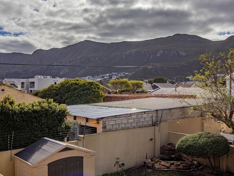 Elevated view overlooking the surrounding residential neighbourhood with a prominent mountain range backdrop.