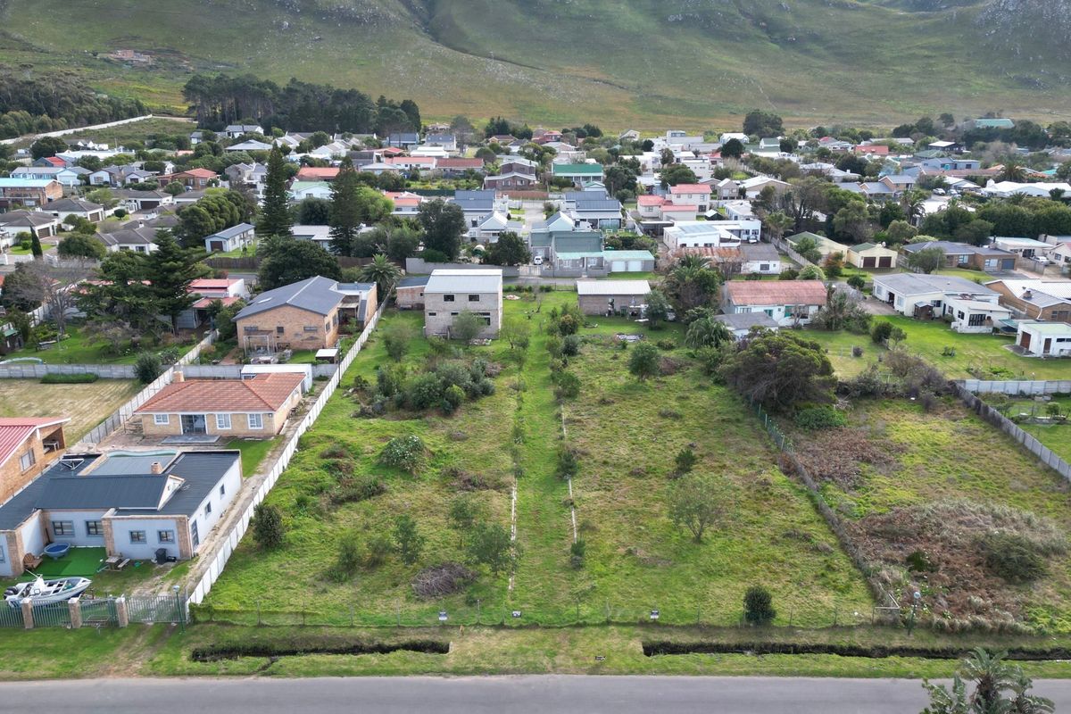 An aerial view of a vacant residential plot situated in a developed neighborhood, offering a clear perspective of the land and surrounding properties.