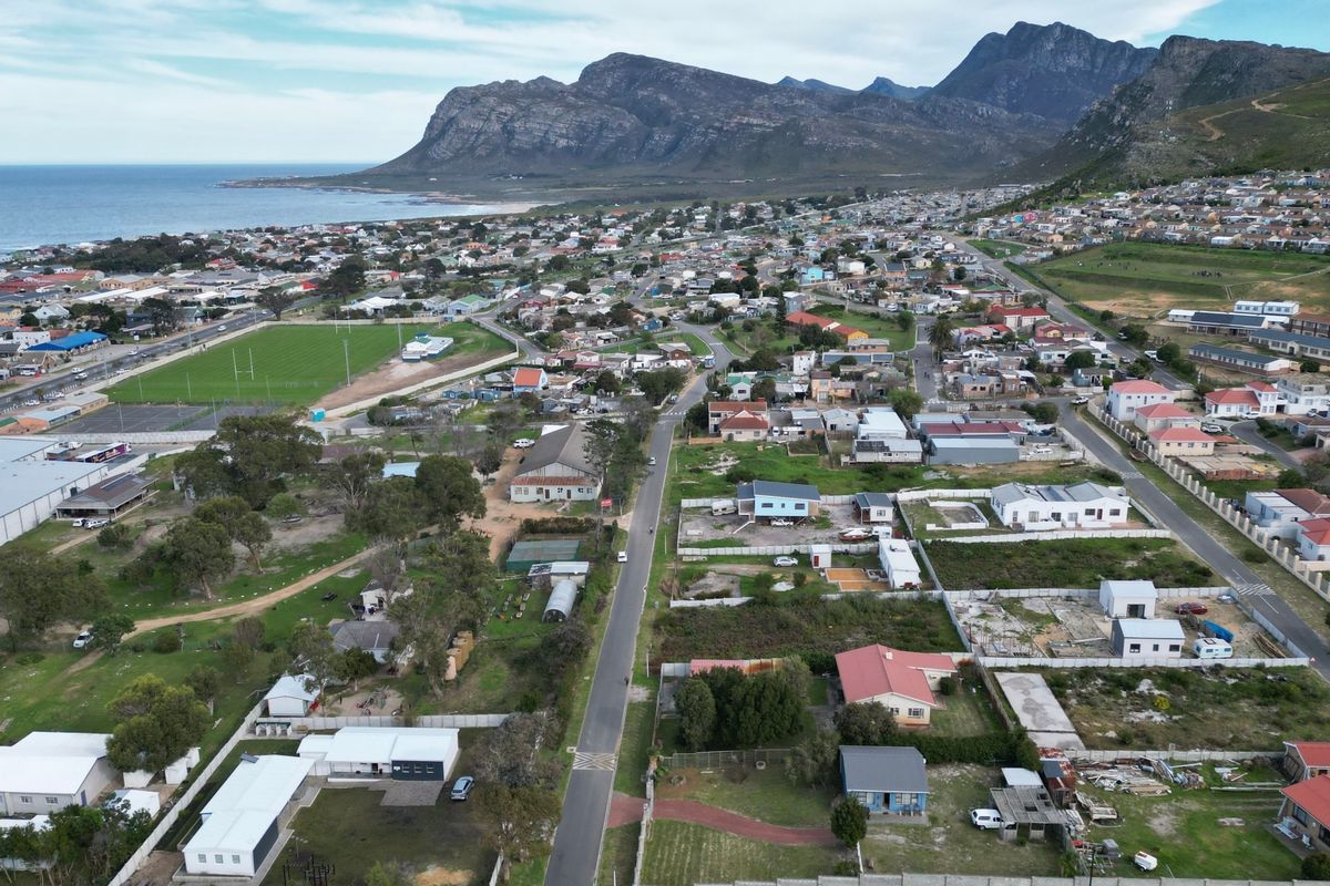Aerial view of a coastal residential neighborhood featuring mountain vistas and proximity to the ocean.