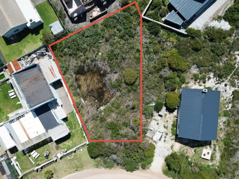 Aerial view of a vacant residential plot with defined boundaries, situated in a developed neighborhood.