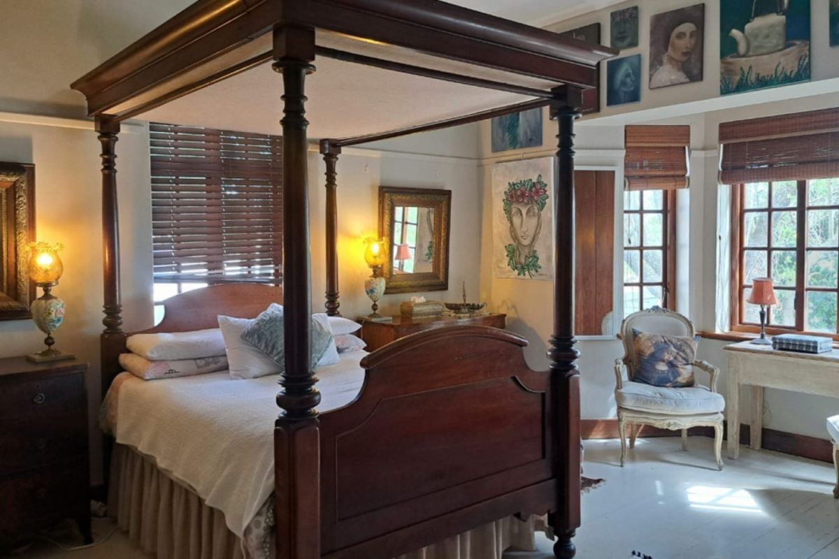 A well-maintained bedroom featuring classic timber window frames, wooden blinds, and traditional picture rails, offering a warm and inviting atmosphere.