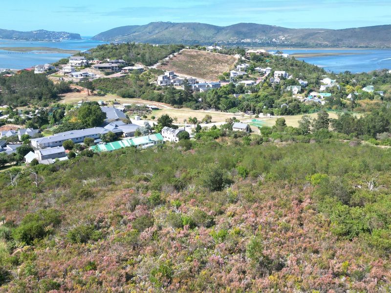 An elevated aerial view of the vacant residential land, showcasing the surrounding coastal landscape, estuary, and established neighborhood.