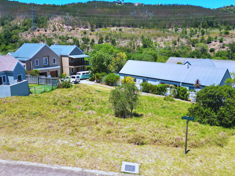 A vacant residential plot situated in a developed neighborhood, featuring street access and proximity to existing residential properties.