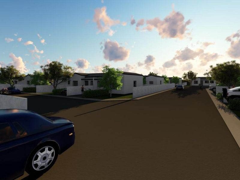A digital rendering showing a residential street scene with paved roads and boundary walls surrounding the properties.
