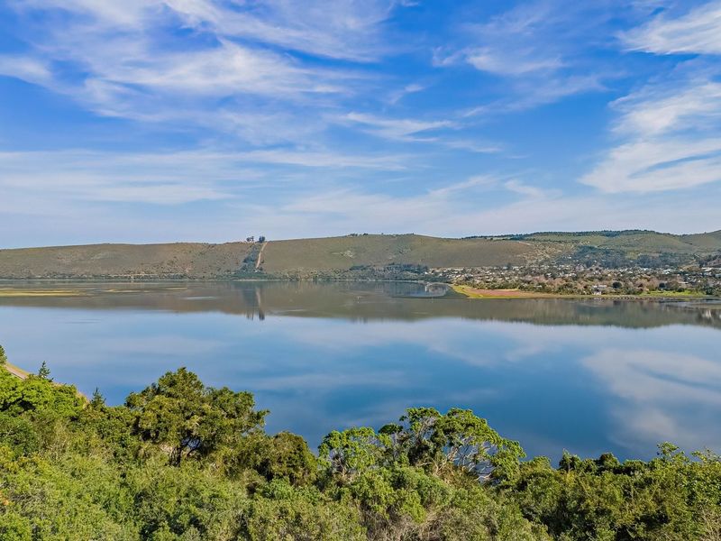 A scenic, elevated view overlooking a calm lagoon and surrounding hills, showcasing the natural landscape and tranquil environment of the property location.