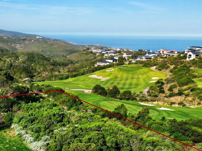 Aerial view of a residential vacant land plot overlooking a golf course with scenic coastal and mountain views in the background.