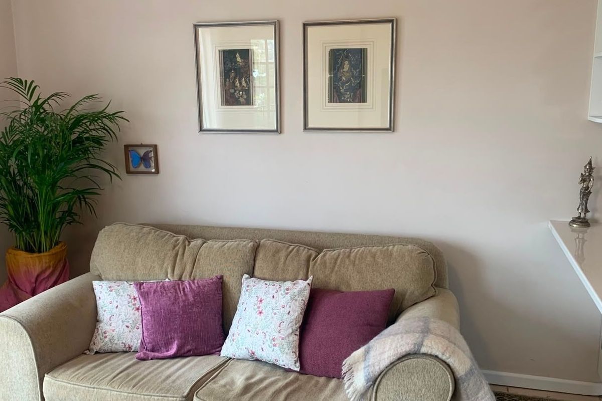 A living room area featuring a built-in shelf and a side counter surface, providing functional storage and display space within the apartment.