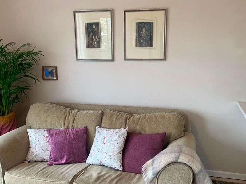 A living room area featuring a built-in shelf and a side counter surface, providing functional storage and display space within the apartment.