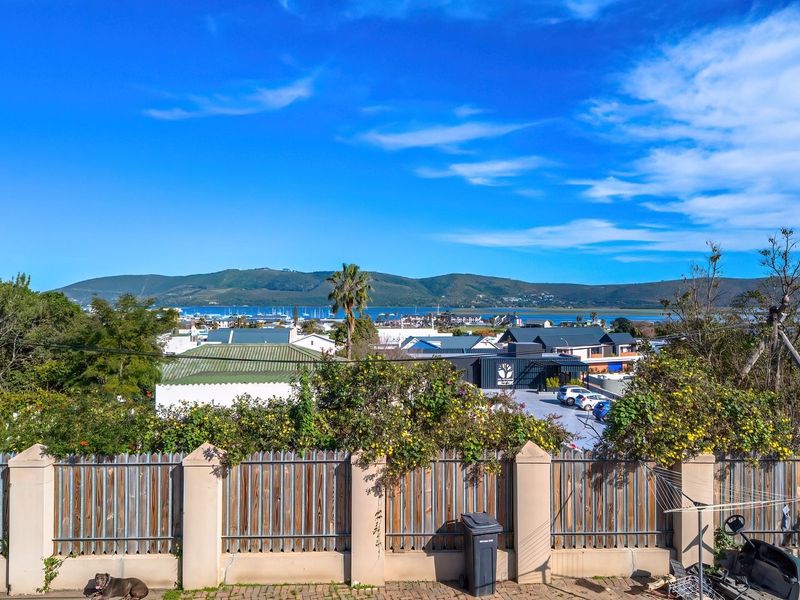 Elevated view overlooking the surrounding neighbourhood, coastal landscape, and distant mountains.
