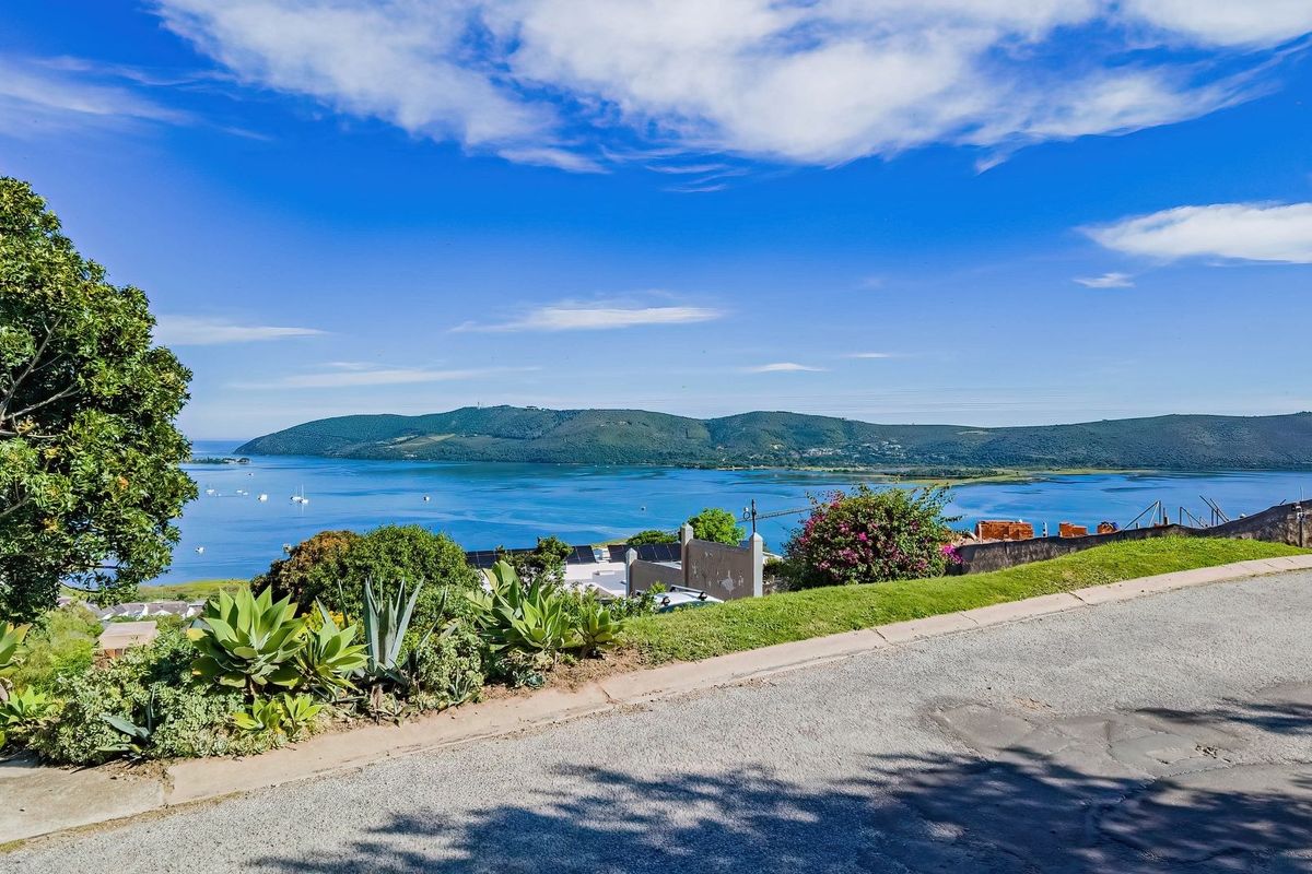 A scenic elevated view overlooking the lagoon and surrounding hills, showcasing the natural landscape and coastal setting of the vacant residential land.