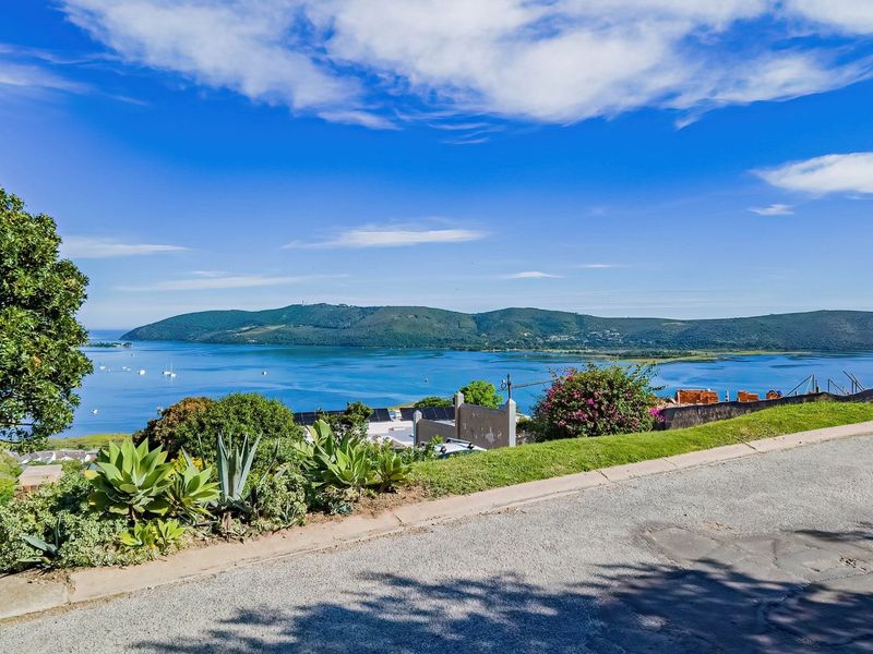 A scenic elevated view overlooking the lagoon and surrounding hills, showcasing the natural landscape and coastal setting of the vacant residential land.