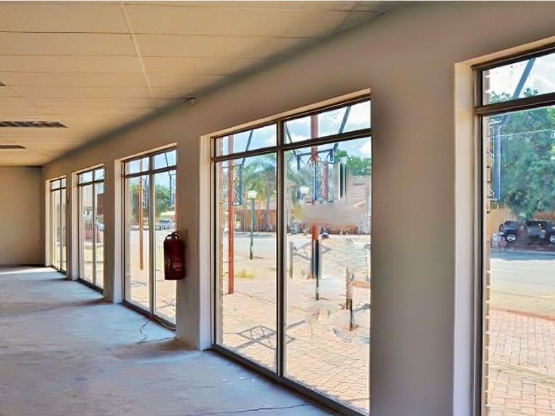 Spacious open-plan retail area featuring large display windows, suspended ceilings with recessed lighting, and a neutral interior ready for custom fit-out.