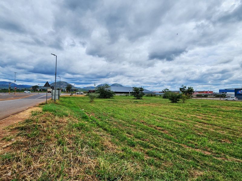 A view of the vacant commercial land parcel situated adjacent to a public road with established street lighting and surrounding commercial infrastructure.