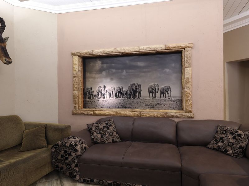 A living room featuring crown molding and a decorative stone-framed wall feature, providing a unique focal point for the space.