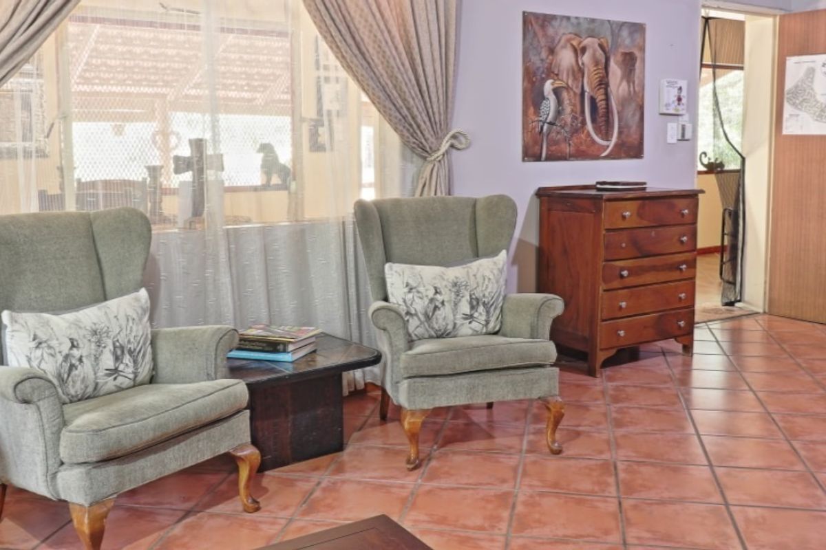 A living area featuring traditional terracotta floor tiles and large windows, providing a warm and classic foundation for interior updates.