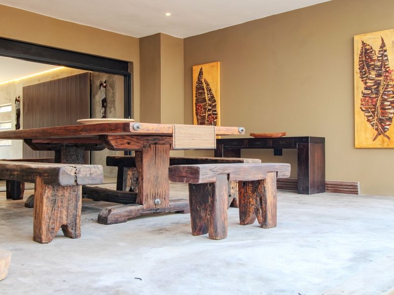 A spacious covered patio featuring smooth concrete flooring and large sliding glass doors that provide seamless access to the interior living space.