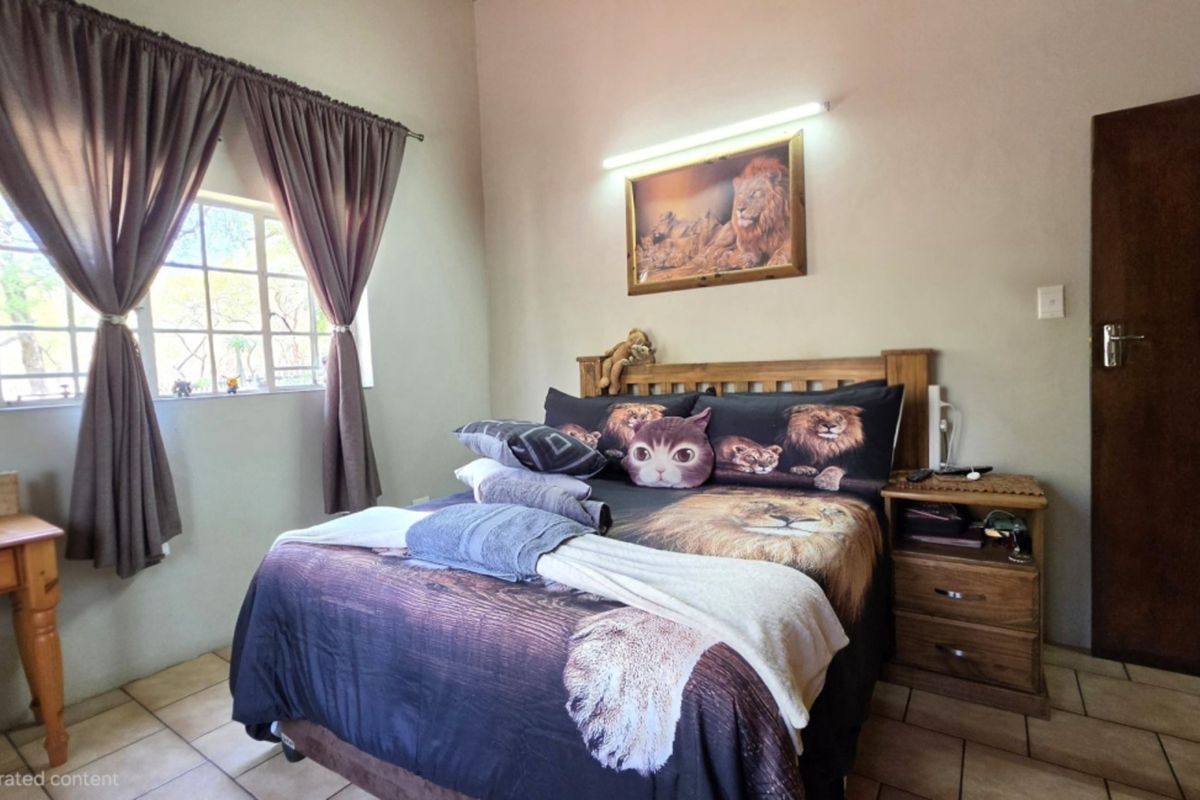 A functional bedroom featuring tiled flooring, a window with curtains, and a standard door.
