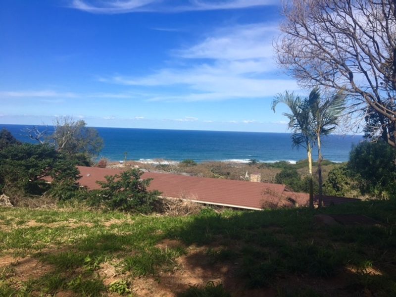 A scenic elevated view overlooking the coastline and ocean, showcasing the property's prime location and natural surroundings.