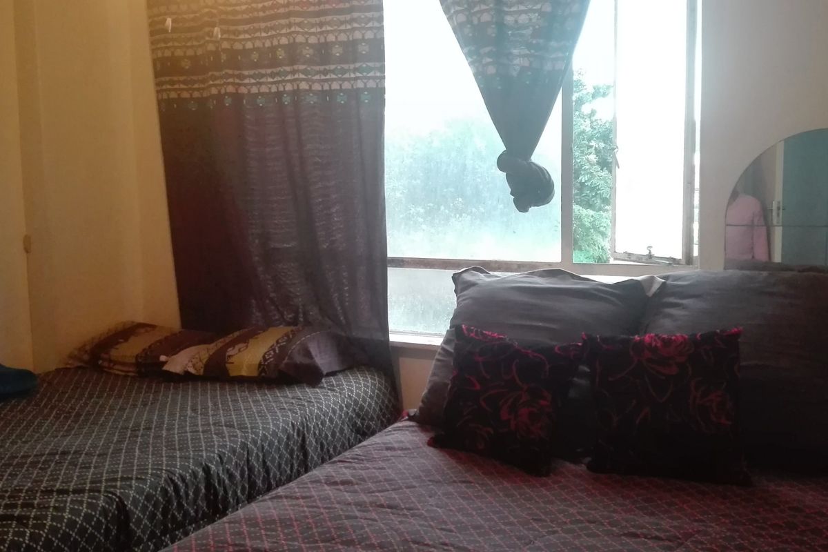 A bedroom featuring a window with natural light, providing a functional space for rest.
