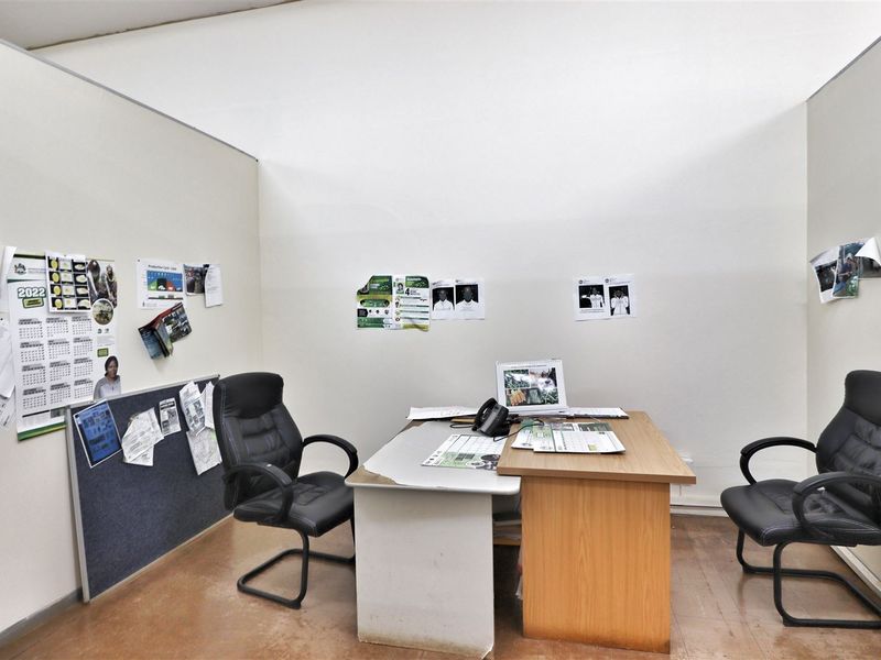 A compact office space featuring partition walls and standard flooring, suitable for a private workspace or consultation room.
