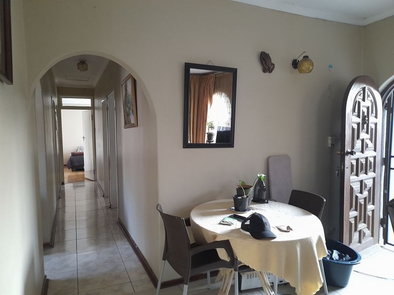 Entrance area featuring tiled flooring, an arched transition to the hallway, and a solid wood front door.