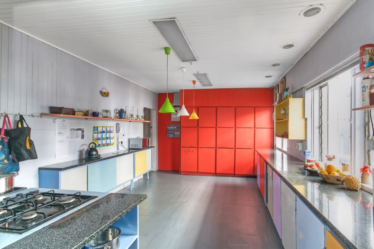 Spacious kitchen featuring extensive built-in cabinetry, granite countertops, a gas hob, and recessed ceiling lighting.