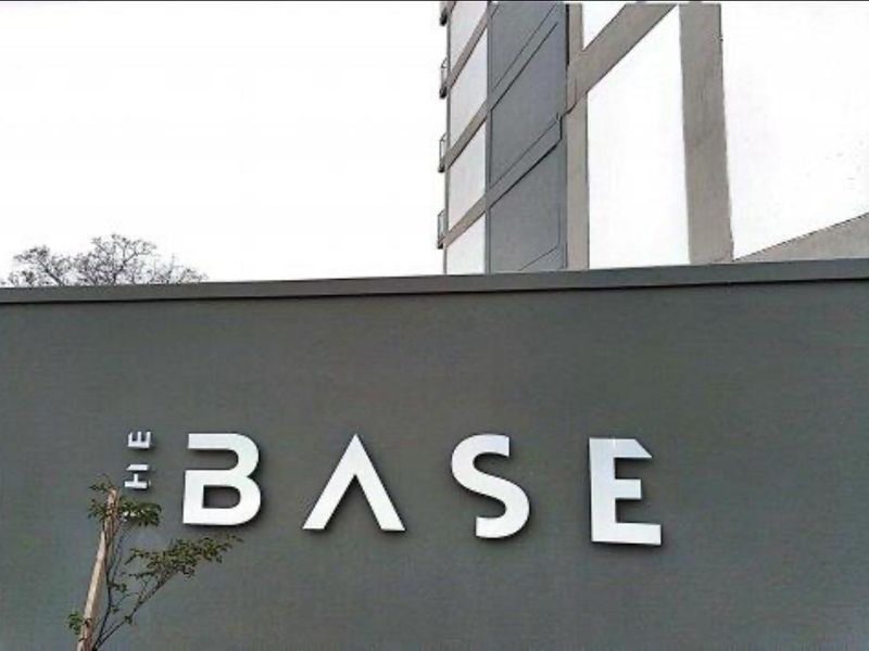 Exterior view of the apartment complex entrance featuring the building signage on a modern boundary wall.