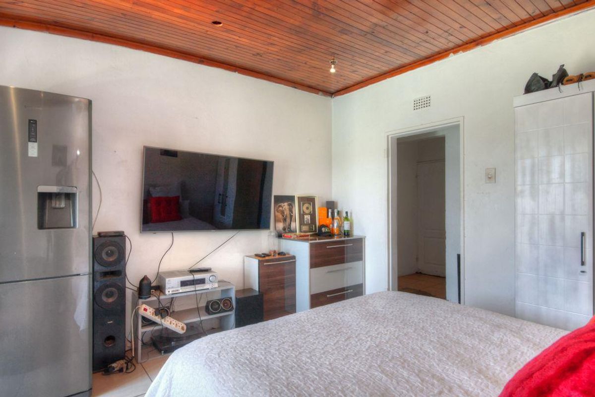Bedroom featuring a timber-clad ceiling and built-in wardrobe storage.