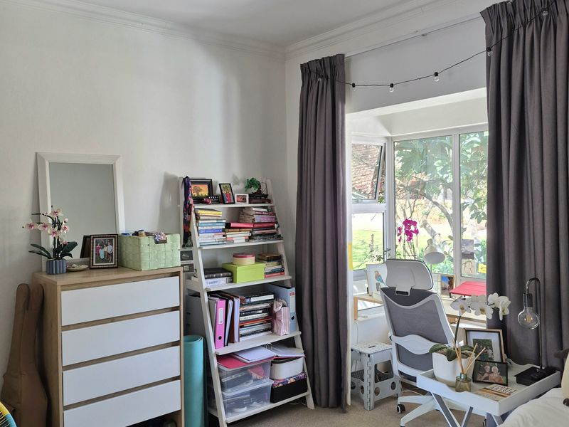 A bedroom featuring a bay window, neutral carpet flooring, and coving, providing a functional space with natural light.