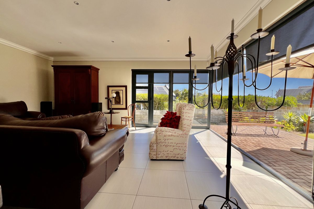 Spacious living area featuring large sliding glass doors that provide seamless access to the outdoor patio and garden.
