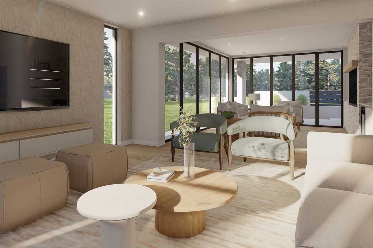 A bright, modern living room featuring large glass sliding doors, hardwood flooring, and a stone feature wall, offering seamless indoor-outdoor flow.