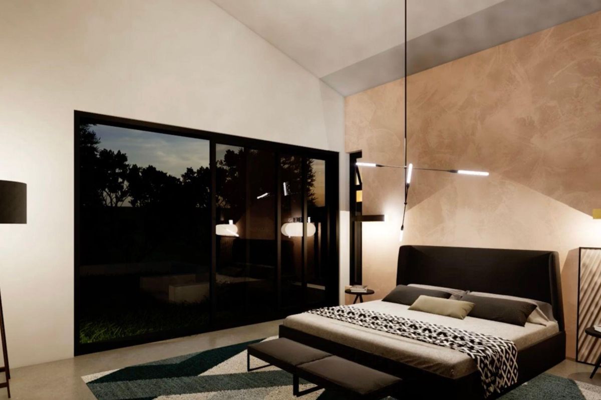 Modern bedroom featuring high vaulted ceilings, large sliding glass doors providing outdoor access, and a textured feature wall with contemporary lighting.