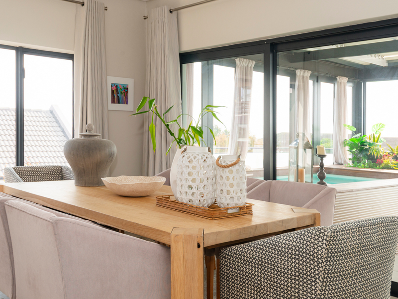 Bright dining area featuring large sliding glass doors that provide seamless access to an outdoor patio space.