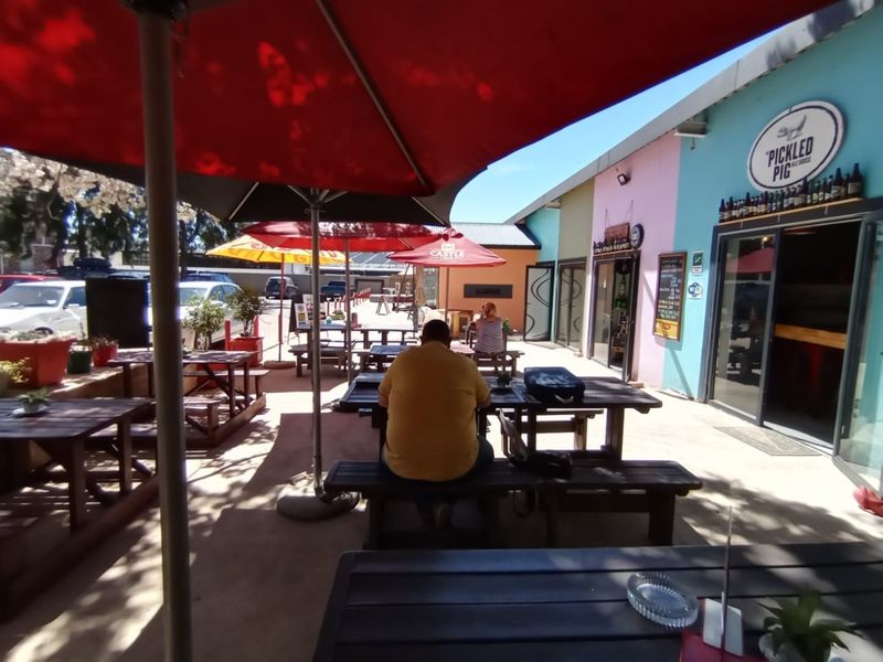 Outdoor patio area featuring paved flooring and direct access to the business premises, suitable for casual dining and social gatherings.