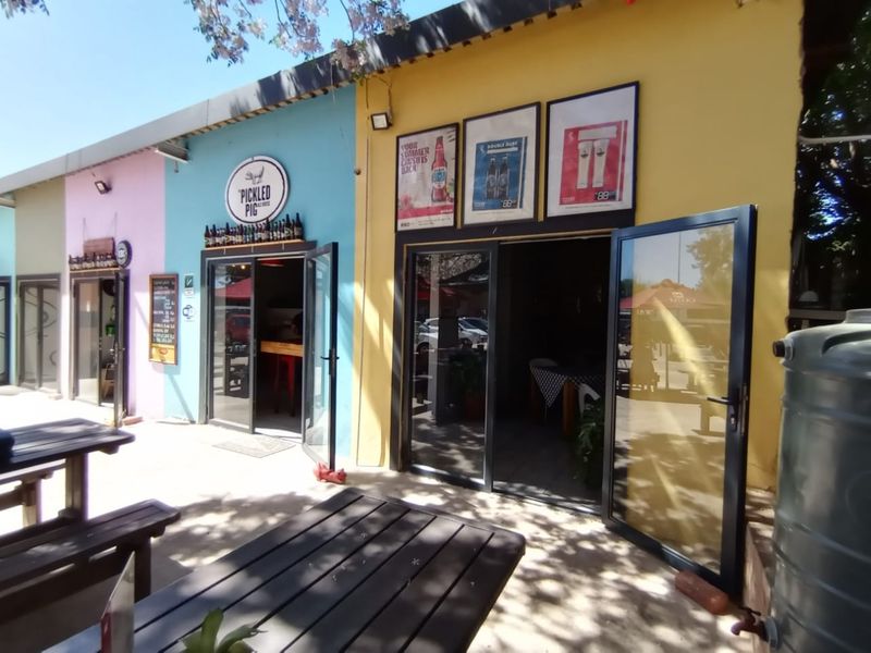 Exterior view of a commercial property featuring multiple entrances with aluminium framed glass doors and vibrant painted facade walls.