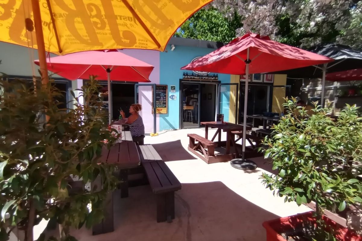 Outdoor patio area featuring paved flooring and access to the building interior through sliding glass doors, suitable for casual dining or social gatherings.