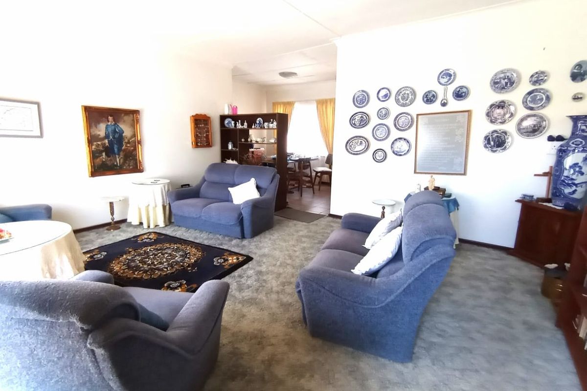 A spacious living room featuring fitted carpeting and neutral wall finishes, providing a comfortable and functional area for relaxation.