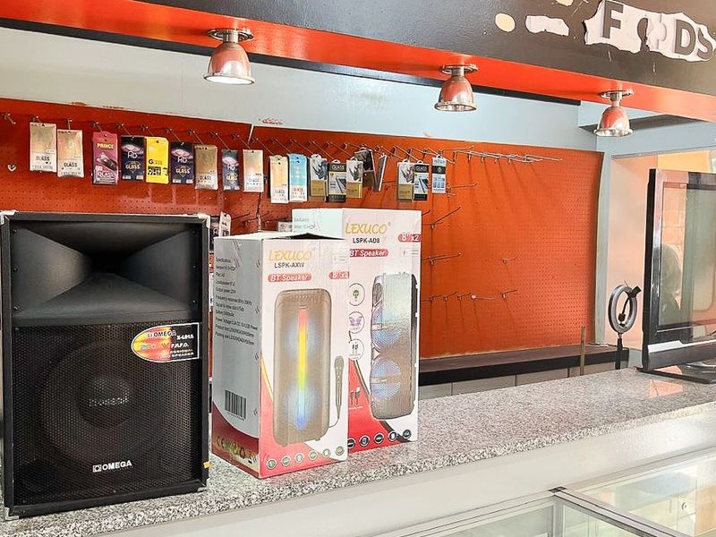 Retail service counter area featuring a granite countertop, pegboard display wall, and overhead recessed lighting.