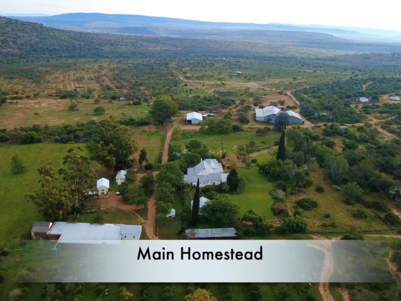 Aerial view of the expansive farm property featuring the main homestead and various outbuildings set within a large rural landscape.