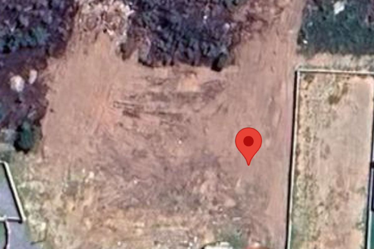 Aerial view of a vacant residential plot showing cleared land and boundary fencing.