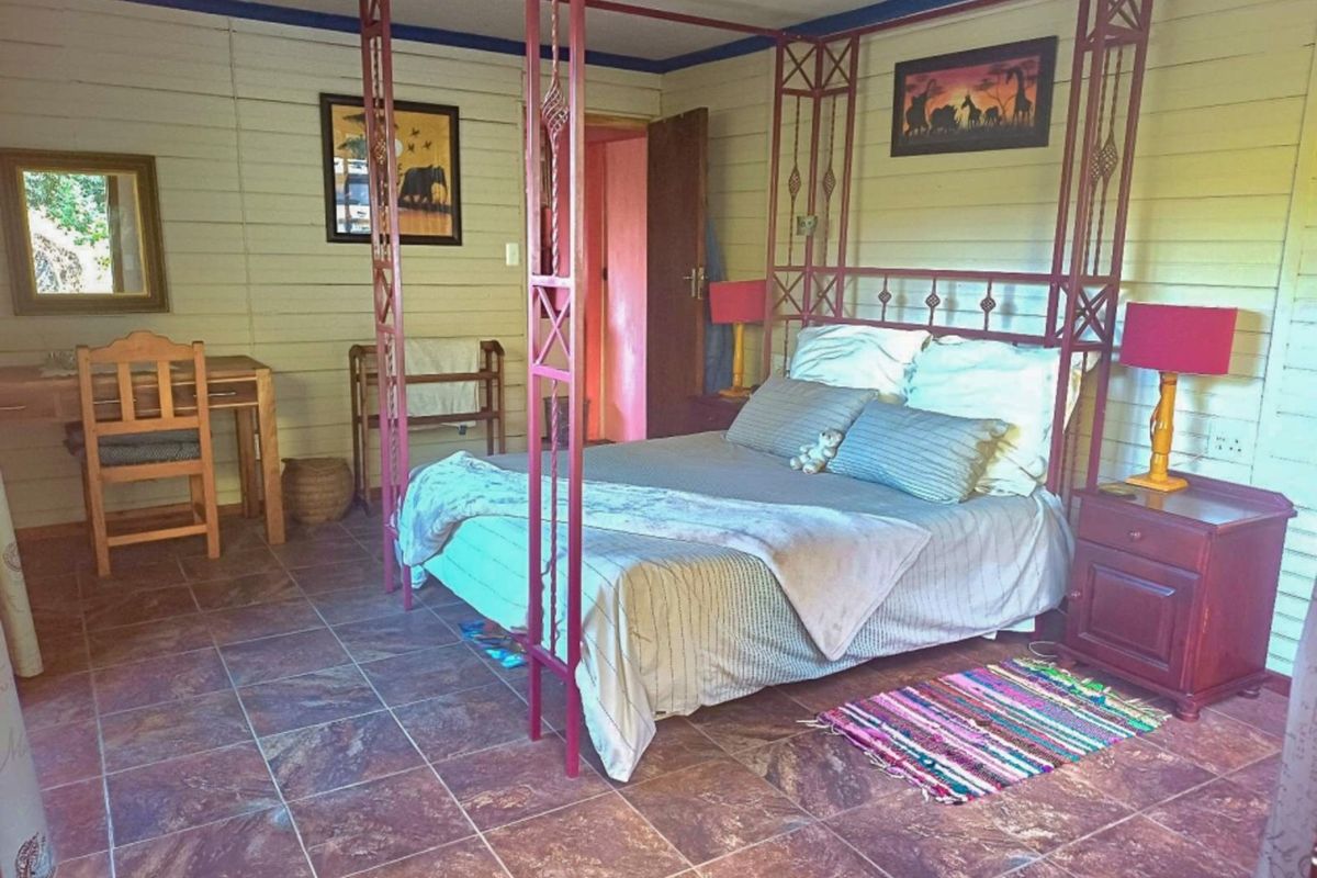 A bedroom featuring timber wall cladding and tiled flooring, providing a rustic aesthetic.