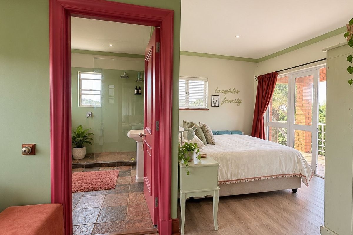 A bright bedroom featuring laminate flooring, an en-suite bathroom with a glass shower, and sliding doors leading to an outdoor area.