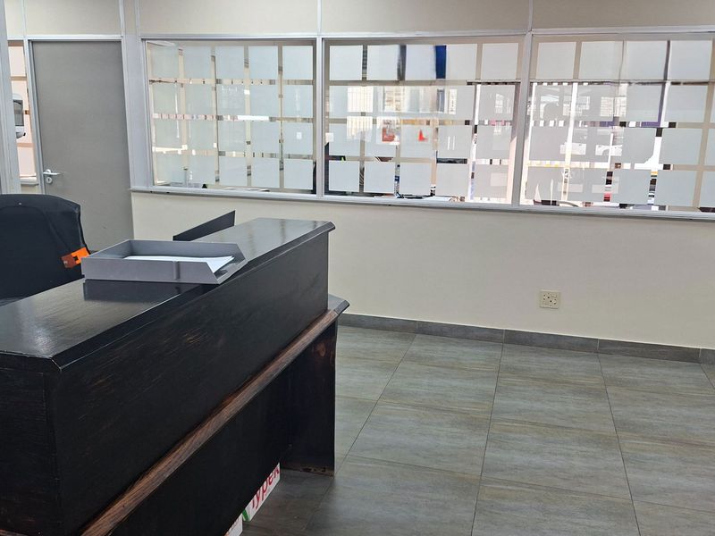 A functional office space featuring tiled flooring and partitioned glass walls, providing a professional environment suitable for administrative or industrial operations.