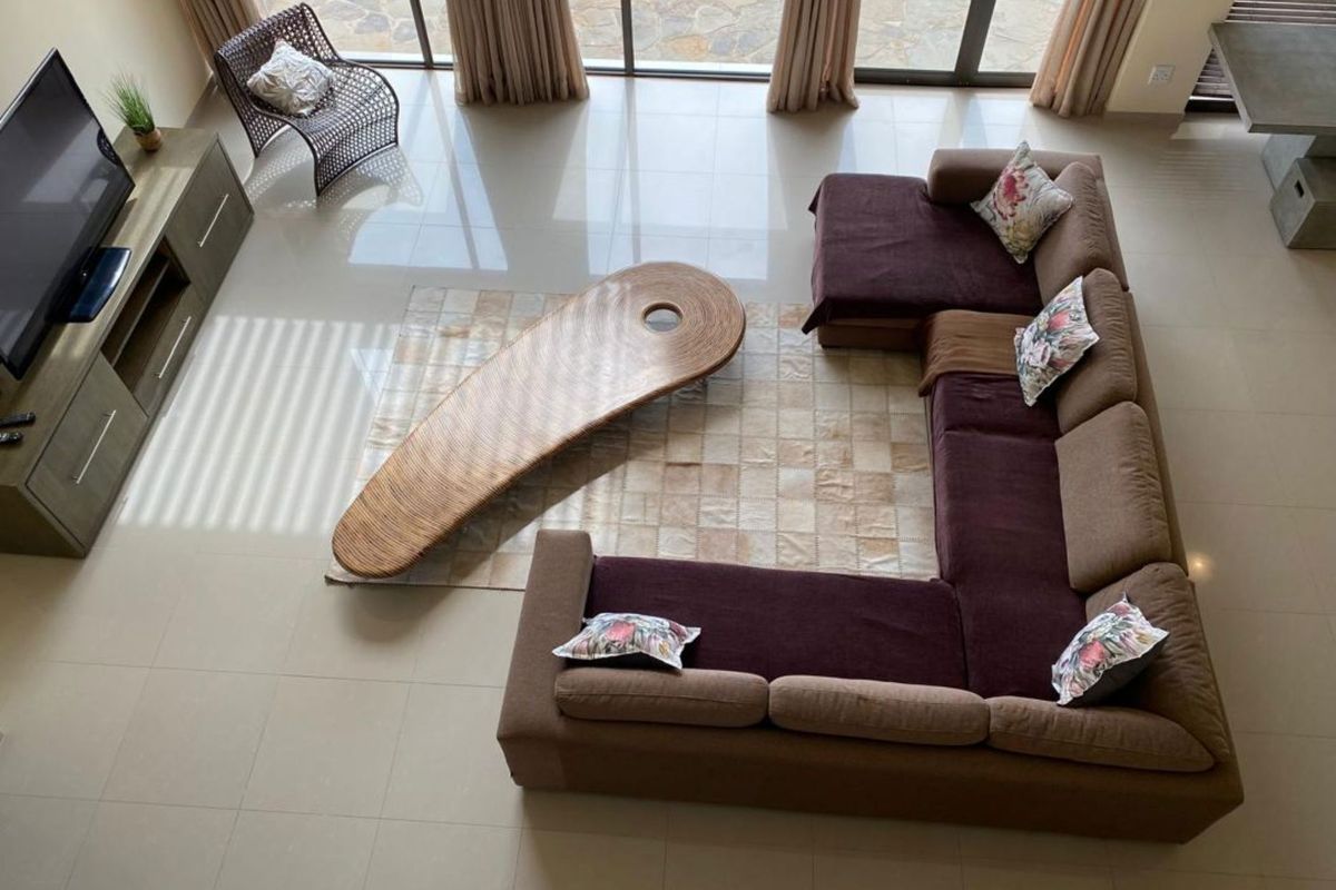 Spacious living area featuring large format floor tiles and expansive sliding glass doors providing seamless access to the outdoor patio area.