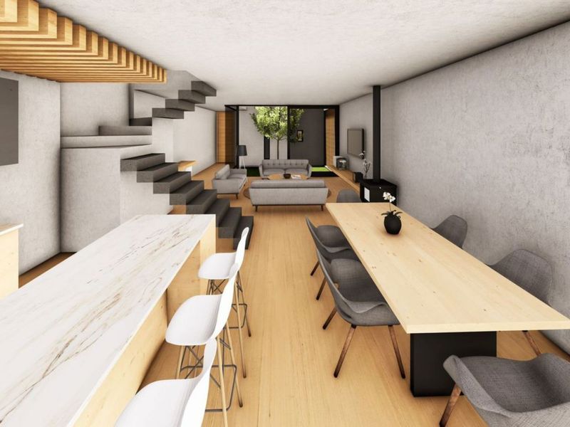 Modern open-plan living area featuring a floating staircase, timber ceiling accents, a wood-burning fireplace, and a sleek kitchen island with hardwood flooring.