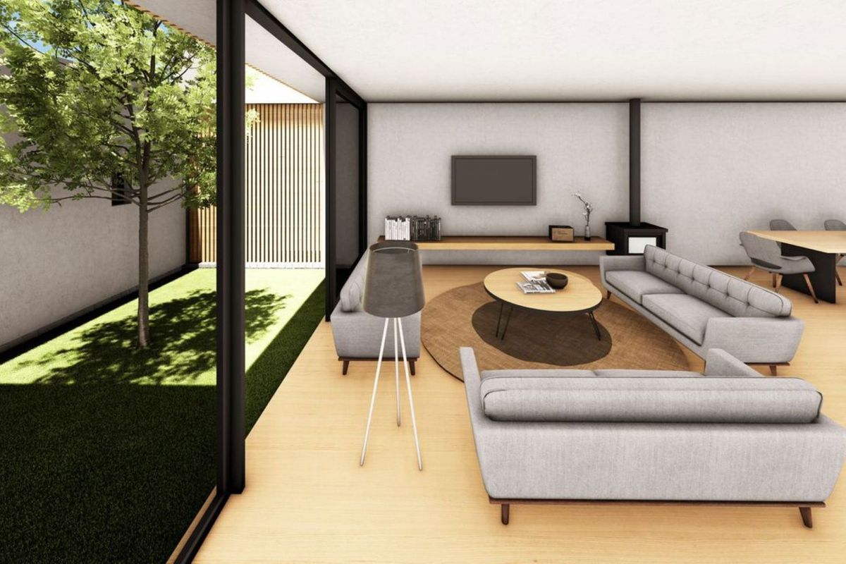 Modern open-plan living and dining area featuring timber flooring, a fireplace, and seamless indoor-outdoor flow through large sliding glass doors to a private garden.