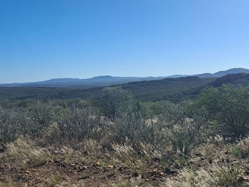 A scenic landscape view showcasing the expansive natural terrain and rolling hills characteristic of the surrounding farm environment.