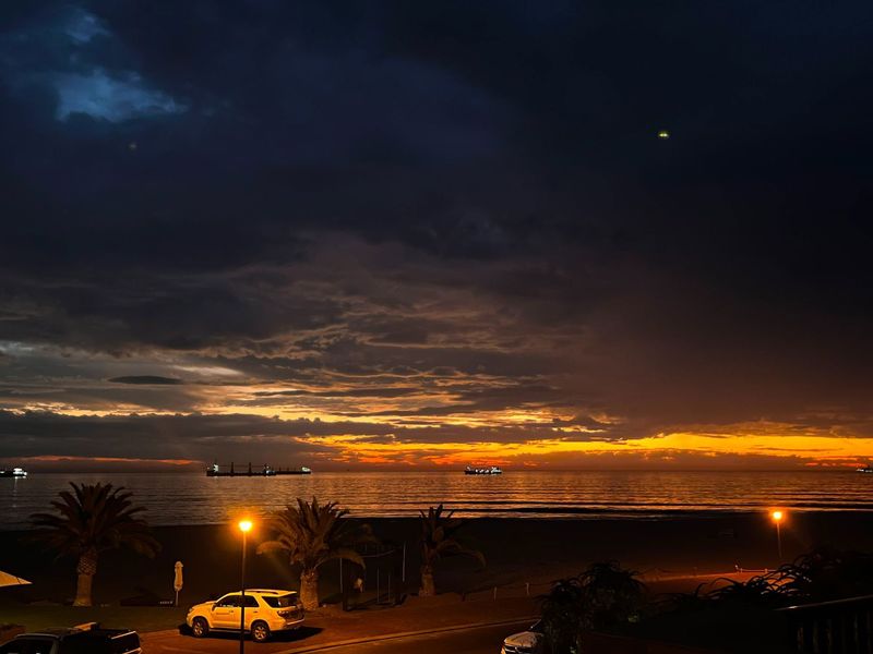 A scenic sunset view over the ocean, capturing the horizon and coastal atmosphere at dusk.